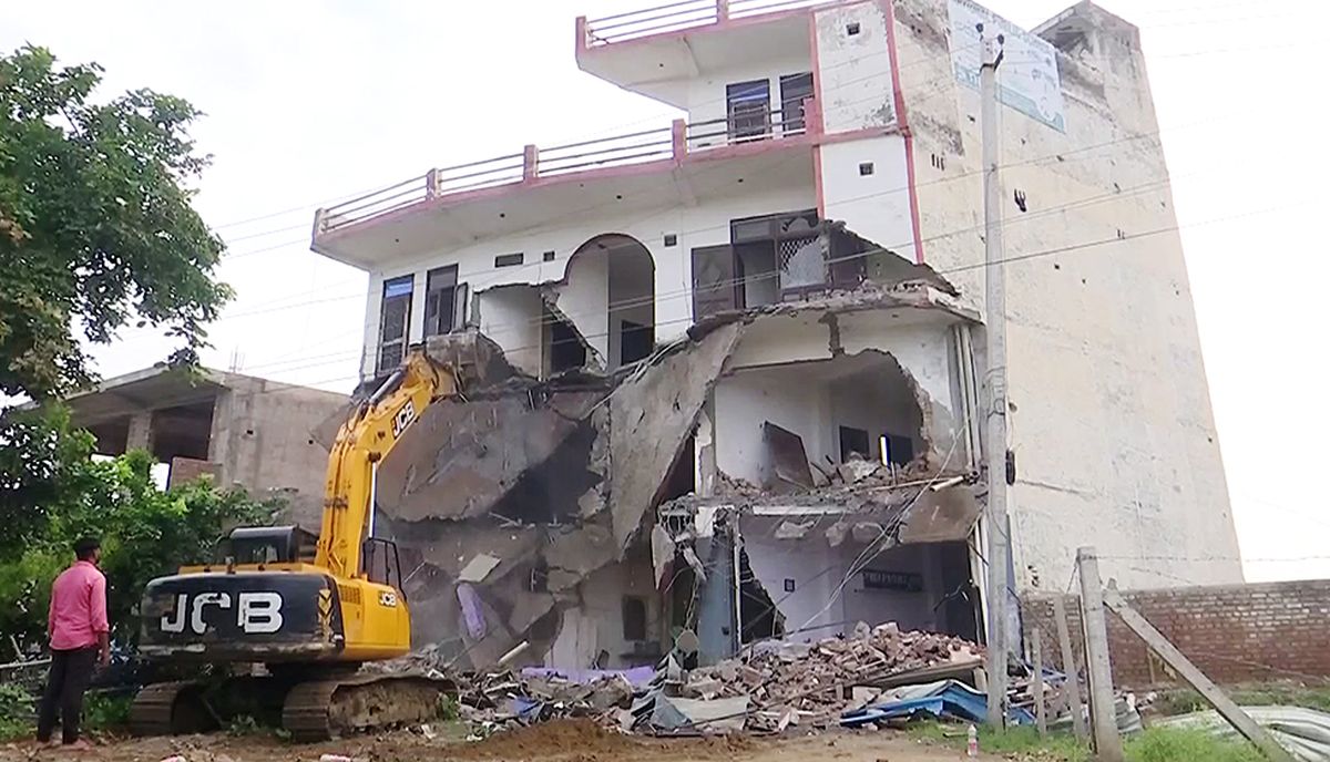 An illegal hotel-cum-restaurant being demolished in Nuh